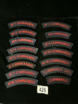 A QUANTITY OF MILITARY COMMANDO SHOULDER TITLES