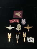 A QUANTITY OF MILITARY METAL AND CLOTH CAP BADGES, INCLUDING; SAS, ARTISTS RIFLES AND MORE