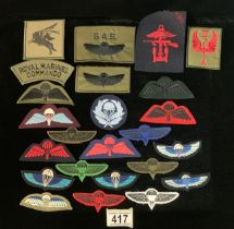 A QUANTITY OF MILITARY CLOTH BADGES INCLUDING; ROYAL MARINES COMMANDO, COMBINED OPERATIONS, RAF