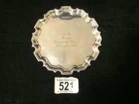 A STERLING SILVER COASTER / SMALL SALVER / DISH BY ROBERT COMYNS; SHEFFIELD 1997; SHAPED BORDER;