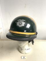 A VINTAGE POLICE MOTORCYCLE HELMET; GREEN AND BEIGE