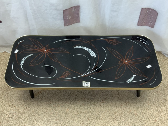 1960s GLASS TOP COFFEE TABLE WITH A FLOWER DESIGN ON SPLAYED LEGS; 92 X 40CM