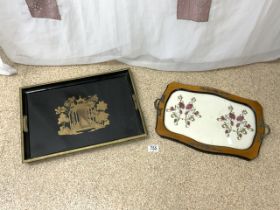 TWO SERVING TRAYS; ONE BLACK LACQUERED; THE OTHER EMBROIDERED