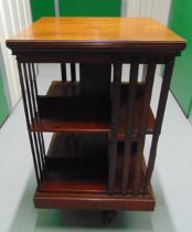 A Mahogany rotating rectangular two level book shelf with pierced slatted sides, A/F, 85.5 x 40.5