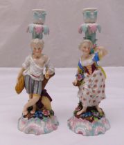 A pair of Augustus Rex figural candlesticks of a boy holding a sheaf of wheat and a girl holding