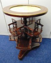 An early 20th century circular mahogany rotating tea table with inset marble top above two