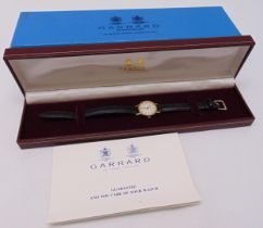 Garrard quartz gold cased ladies wristwatch on leather strap in original packaging