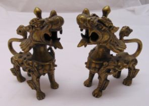 A pair of oriental stylised brass lions, 15cm (h)