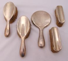 A hallmarked silver dressing table set to include two hair brushes, two clothes brushes and a hand