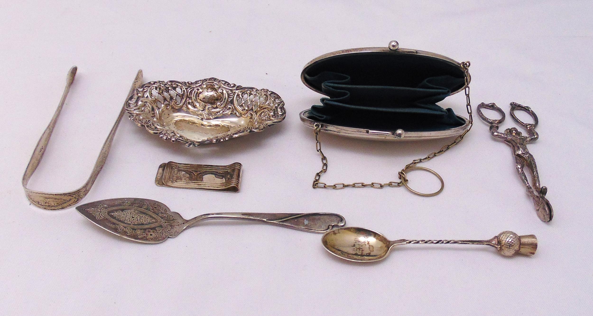 A quantity of hallmarked silver and white metal to include a purse, tongs, bonbon dish, money