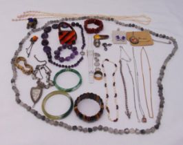 A quantity of costume jewellery to include necklaces, jade bangle, bracelets, earrings and a ring