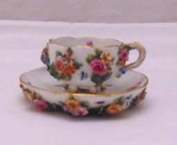 Meissen cabinet cup and saucer with applied flowers and leaves, marks to the bases, slight loss of