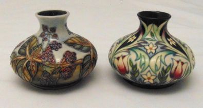 Two Moorcroft squat vases decorated with flowers and leaves, marks to the bases, each 10.5cm (h)