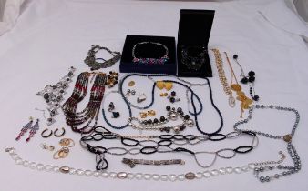 A quantity of costume jewellery to include Swarovski necklaces and earrings