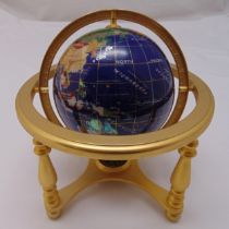 A table top composite globe with compass to the base supported by a brass frame, 25 x 23cm