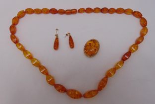 9ct gold and amber brooch, 9ct gold and amber earrings and an amber necklace