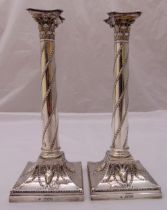 A pair of Victorian hallmarked silver table candlesticks, of corinthian column form with husk