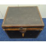 A rectangular leather bound trunk with studded hinged cover to reveal lined interior