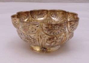 A late Victorian hallmarked silver shaped circular bowl, lobbed sides chased with flowers and leaves