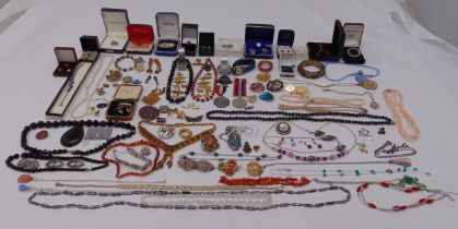 A quantity of costume jewellery to include necklaces, bracelets, brooches, earring and watches