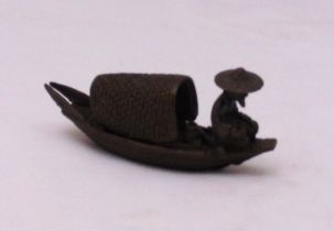 A Japanese Okimono bronze figurine of a fishing boat with fisherman, 10cm (l)