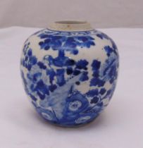A Chinese blue and white spherical ginger jar decorated with prunus blossom, trees, birds and