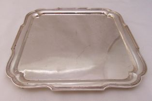A hallmarked silver square tray with reeded borders on four bracket feet, London 1935, approx