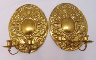 A pair of Victorian brass two branch wall sconces with oval leaf chased back plates, 38 x 30cm