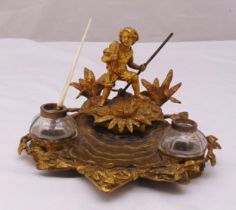 A French late 19th century Ormolu desk stand in the form of a figure on a desert island, with two