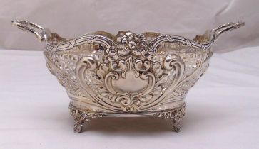 A Victorian hallmarked silver bread basket, oval pierced sides with scroll and leaf chased panels,