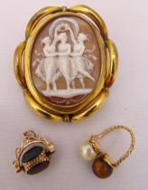 A Victorian cameo brooch, a pearl and tigers eye ring and a coloured stone swivel