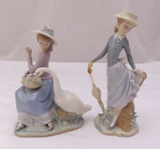 Two Lladro figurines of ladies one with a goose eating out of her basket the other with an umbrella,