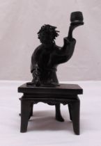 An oriental bronze figurine of a scholar at his desk, 23.5cm (h)