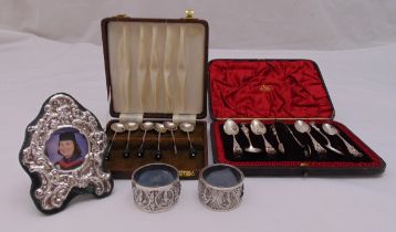 A quantity of hallmarked silver and white metal to include cased coffee and teaspoons, two napkin
