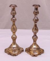 A pair of hallmarked silver table candlesticks, tubular knopped form engraved with flowers and