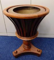 An early 20th century Regency style mahogany slatted campagna form plant pot holder on triangular