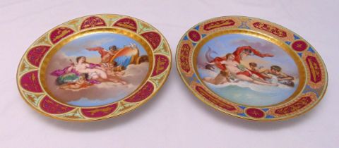 A pair of early 20th century Vienna porcelain chargers by Ackermann and Fritze decorated with