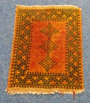 A Persian wool Prayer rug with orange ground and repeating geometric pattern, 72 x 56cm