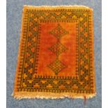 A Persian wool Prayer rug with orange ground and repeating geometric pattern, 72 x 56cm