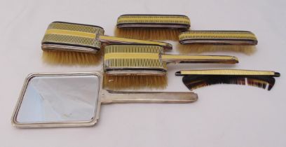 An Art Deco hallmarked silver and enamel dressing table hand mirror, hair and clothes brushes and