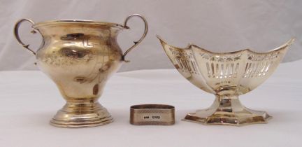 A hallmarked silver two handled sugar bowl on raised circular base, a pierced oval bonbon dish on