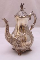 A Victorian hallmarked silver coffee pot, pear shaped profusely chased with flowers, scrolls and