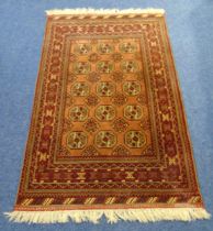 A Persian wool carpet, burgundy ground with repeating geometric pattern and border, 210 x 128cm