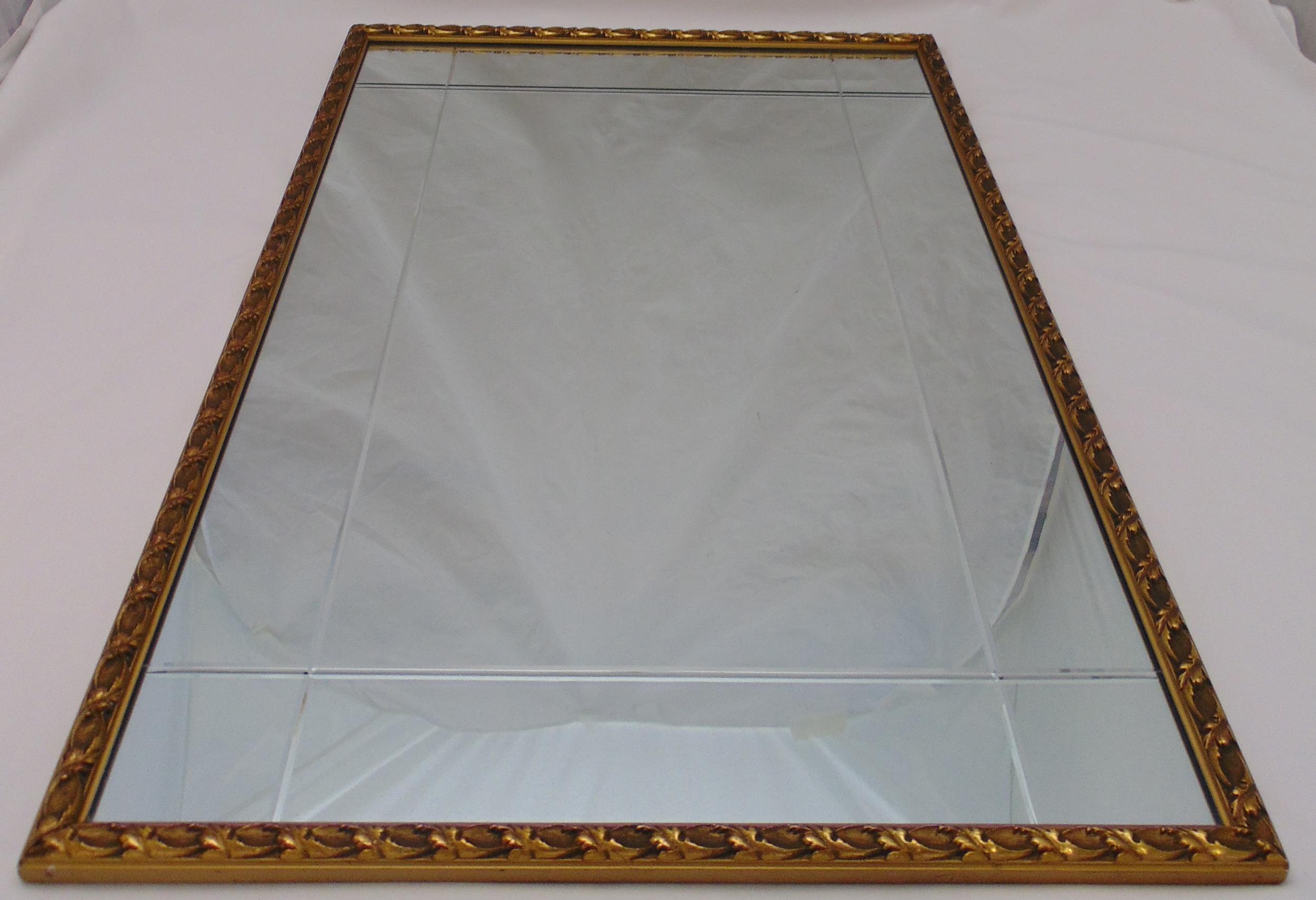 A framed rectangular bevel edged wall mirror, 96 x 65cm
