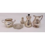 A quantity of hallmarked silver and white metal to include a cream jug, a sugar bowl, a pepper