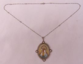 A Madonna pendant set with seed pearls on a platinum chain, signed A Rijis dated 1919
