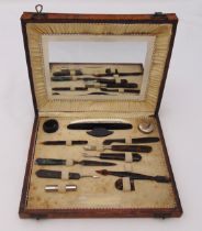 A mid 20th century cased manicure set with tortoiseshell handles to include a nail buffer, a nail