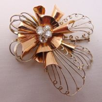 Rose and white gold flower brooch set with four diamonds, tested 14ct, approx total weight 20.6g