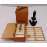 A quantity of microscope slides in fitted wooden case, approx 75 and a Britex mirror microscope in