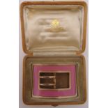 A silver gilt and enamel buckle in the Faberge style, unmarked in an original fitted hollywood case
